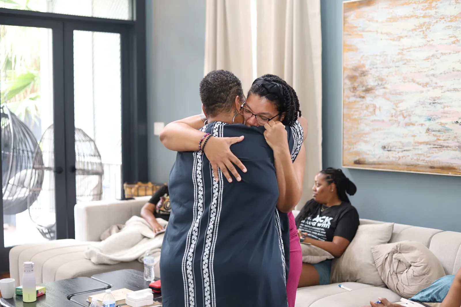 Two women embracing in a warm hug during the retreat